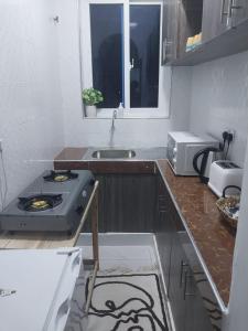 a kitchen with a stove and a sink at C.leslie_homes in Bamburi