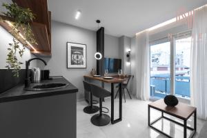 a kitchen with a desk and a table in a room at Hermes Suites, Agia Sofia, Nilie Hospitality MGMT in Thessaloniki