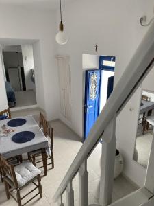 a room with a table and a blue vending machine at Sea Esta Serifos Stylish Family Home, Sea View in Serifos Chora +16 photos