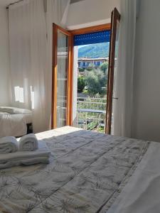 a bedroom with a bed with towels on it at Hotel Luisa in Brenzone sul Garda