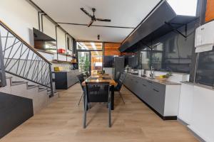 a kitchen with a table and some chairs in it at Orange Apartment&Spa Okrug Gornji in Trogir