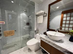 a bathroom with a toilet and a sink and a shower at Samatha Hotel Bai Chay, Ha Long in Ha Long