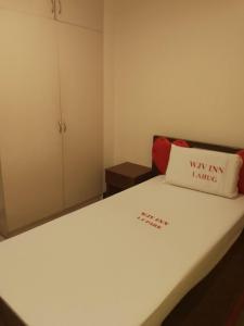 a small room with a bed with a pillow on it at WJV INN LAHUG in Cebu City +1 photo
