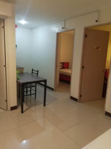 a room with a table and a room with a bed at WJV INN LAHUG in Cebu City