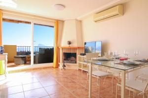 a dining room with a table and a fireplace at Precioso bungalow con piscina - MASCARAT in Altea la Vieja