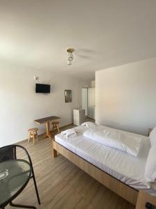 a bedroom with a large bed and a table at Kherim 2 in Tuzla +17 photos