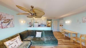 a living room with a couch and a ceiling fan at Villas by The Sea Resort by Jekyll Realty in Jekyll Island