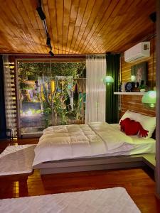 a large bed in a room with a large window at Butiq Garden in Kemer