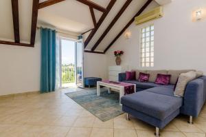 a living room with a couch and a table at Apartment Alba in Cavtat