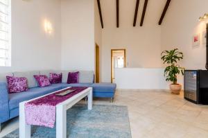 a living room with a blue couch and a table at Apartment Alba in Cavtat