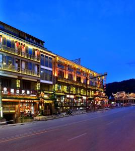 a large building on a city street at night at SecGarden Boutique Hotel in Zhangjiajie