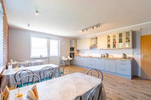 a kitchen and dining room with tables and chairs at Pod Platanem in Rowy