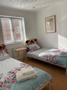 a room with two beds and a chair in it at Townhouse at Harlepool Marina in Hartlepool