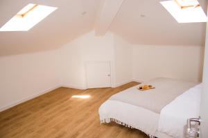 a bedroom with a bed in a attic with skylights at Apartamento São Miguel - Santa Catarina Place in Ponta Delgada