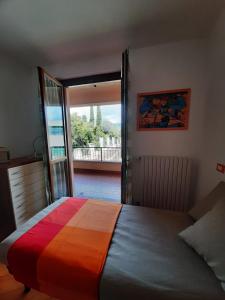 a bedroom with a bed with a colorful bedspread at La casa al lago BMOR love&lake in Mezzegra