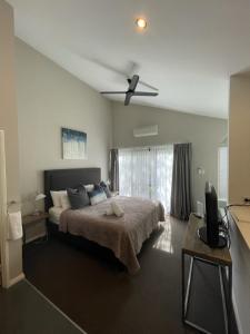 a bedroom with a bed and a ceiling fan at Margarets Forest in Margaret River Town