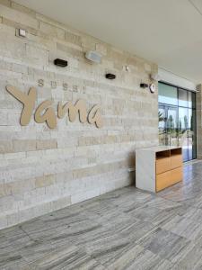 a brick wall with a sign that reads sit still karma at Villa Gracia in Ayia Napa +69 photos