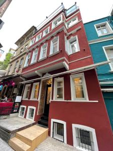 a red building with white windows on a street at The House Company in Istanbul
