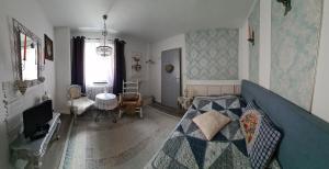 a bedroom with a bed and a living room at Gästehaus Fuchsröhre in Welcherath