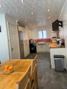 a kitchen with a wooden table with oranges on it at Townhouse at Harlepool Marina in Hartlepool