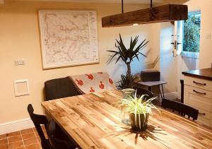 a dining room with a wooden table and a couch at Seata Barn in Askrigg