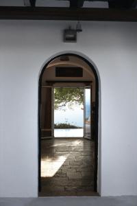 an open door to a building with a window at Villa Heleni in Vouliagmeni Lake