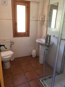 a bathroom with a toilet and a sink and a shower at El Sindicat de Tarrés Camins de Pedra in Tarrés