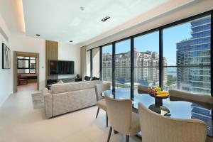 a living room with a view of a city at Cheval Maison - The Palm in Dubai