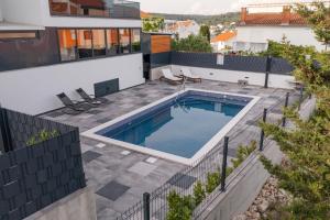 an aerial view of a house with a swimming pool at Orange Apartment&Spa Okrug Gornji in Trogir
