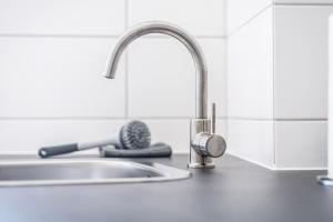 a kitchen counter with a sink and a faucet at Cozy Apartment in Wiesbaden in Wiesbaden +14 photos