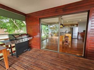 a screened in porch with a grill and a kitchen at Luxury Seaview Getaway in Lopes
