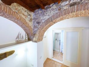 a room with a stone ceiling and a hallway at Casa Cotone - Monolocale in Marciana Marina