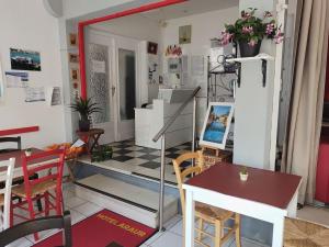 una stanza con tavolo, sedie e specchio di Hotel Araur ad Agde
