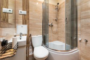 a bathroom with a toilet and a shower at Wałowa 4 by Homeprime in Warsaw