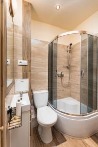 a bathroom with a toilet and a sink and a shower at Wałowa 4 by Homeprime in Warsaw