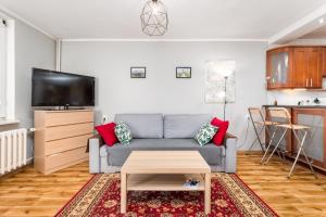 a living room with a couch and a table at Wałowa 4 by Homeprime in Warsaw