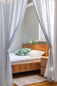 a bedroom with a bed with curtains and a window at Wałowa 4 by Homeprime in Warsaw