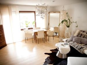 a living room with a table and a dining room at Casa Sofia in Friedrichshafen