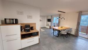 a kitchen with a desk and a table with a microwave at URLAUB LUNZ - Ferienwohnungen Fam. Fürst in Lunz am See