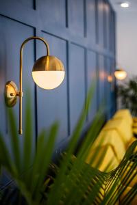 a lamp next to a bench in a room at The Beach House in Canggu