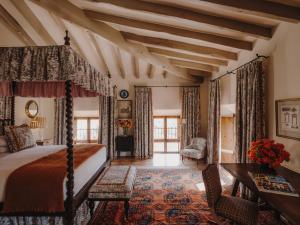 a bedroom with a bed and a table and chairs at Grand Hotel Son Net in Puigpunyent