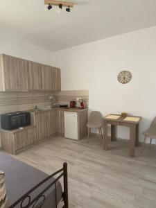 a kitchen with wooden cabinets and a table at Dream Catcher3 in Agia Theodoti