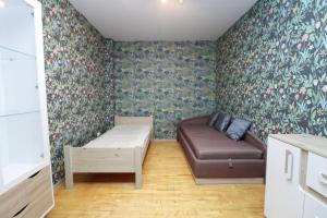 a living room with a couch and floral wallpaper at City-central flat with sauna in Tallinn