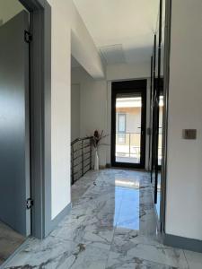 an empty room with a marble floor and a doorway at Villa Marina 4+1 Camuva in Kemer