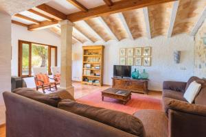a living room with a couch and a tv at Hortella -Ecofinca- in Sant Joan