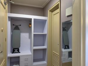 a bathroom with a sink and a mirror at Madina Inn Hotel in Yogyakarta