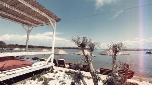 a house with a view of the water with umbrellas at Hotel Erol - Adult Only in Ayvalık