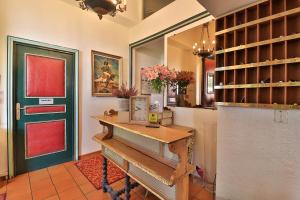a room with a wooden table and a green door at Logis Le Relais Imperial in Saint-Vallier-de-Thiey