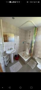 a bathroom with a sink and a tub and a toilet at Zagroda z Antonówką in Szypliszki +26 photos