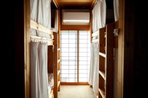 a room with a window and some shelves at 長瀞NEMAKI in Nogami